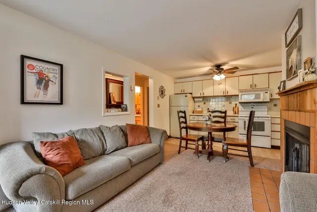 a living room with furniture a ceiling fan and a window