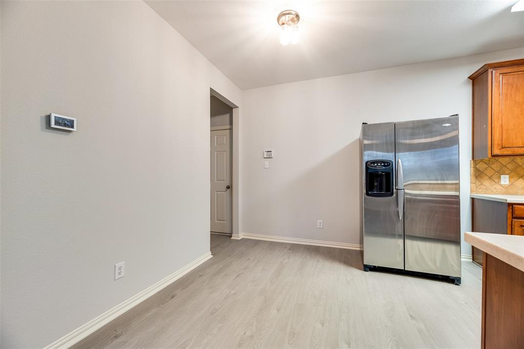 2320 Durango Ridge Drive Bedford, TX 76021 - Photo 6 of 21 a view of a refrigerator in kitchen and an empty room