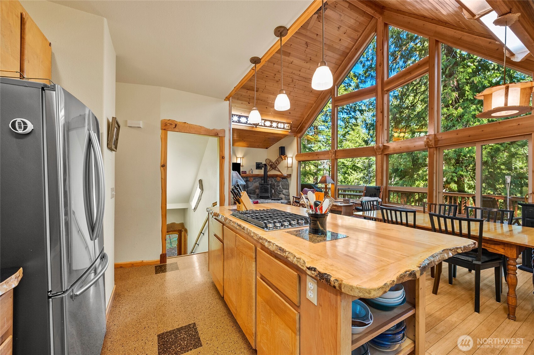 106 Timber Trail Packwood, WA 98361 - Photo 15 of 40 a kitchen with stainless steel appliances granite countertop a table chairs and a refrigerator