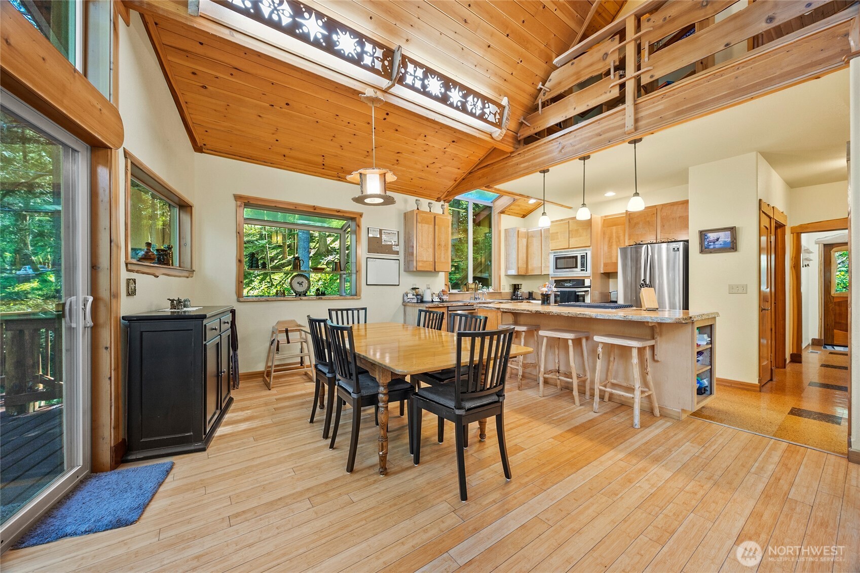 106 Timber Trail Packwood, WA 98361 - Photo 17 of 40 a dining room with stainless steel appliances a dining table chairs and large windows