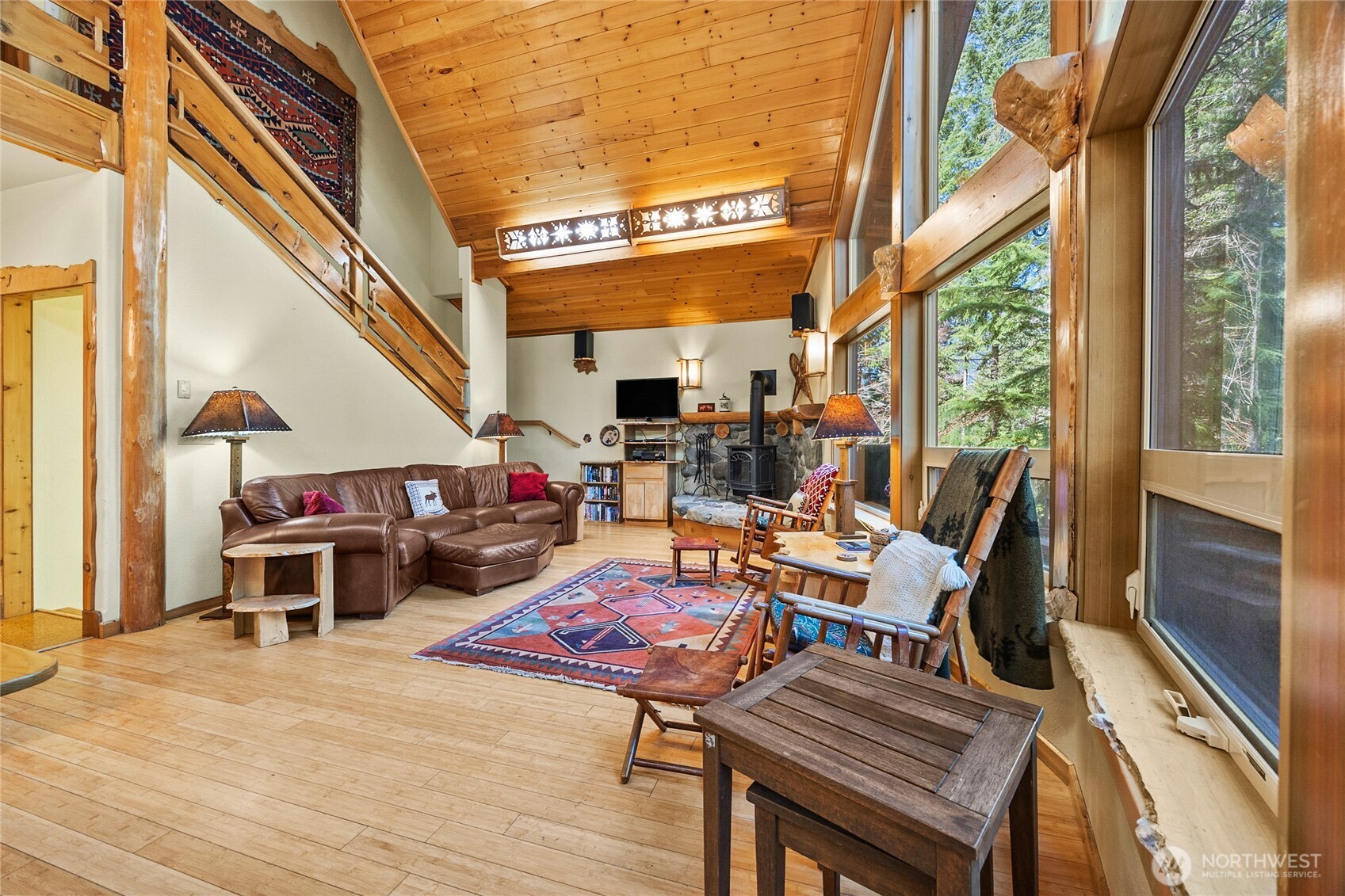 106 Timber Trail Packwood, WA 98361 - Photo 18 of 40 a living room with furniture a fireplace and a large window