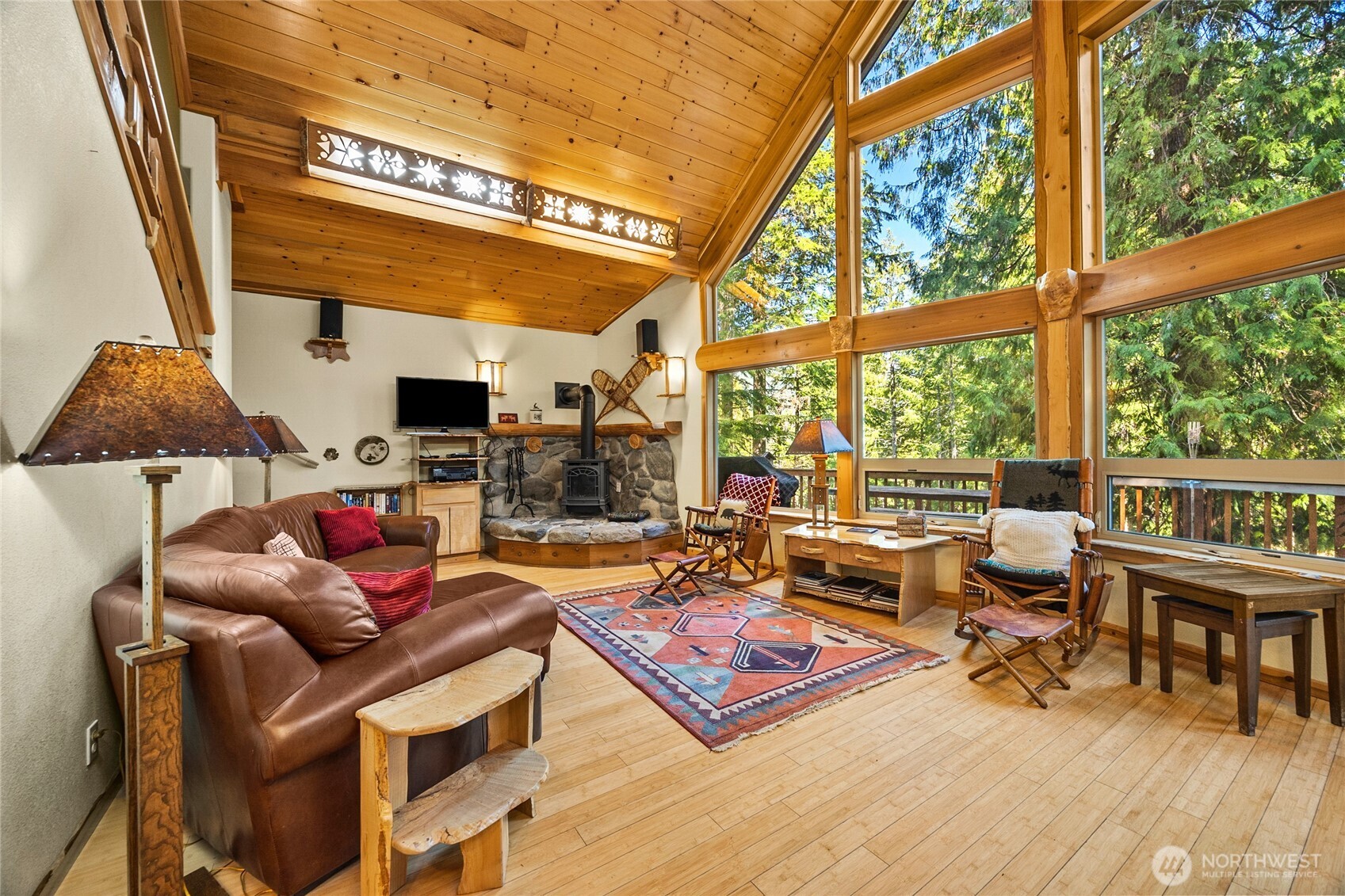 106 Timber Trail Packwood, WA 98361 - Photo 19 of 40 a living room with furniture a fireplace and large windows