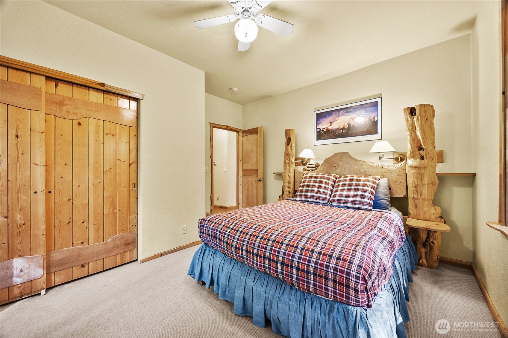 106 Timber Trail Packwood, WA 98361 - Photo 23 of 40 a bedroom with a bed and a chandelier