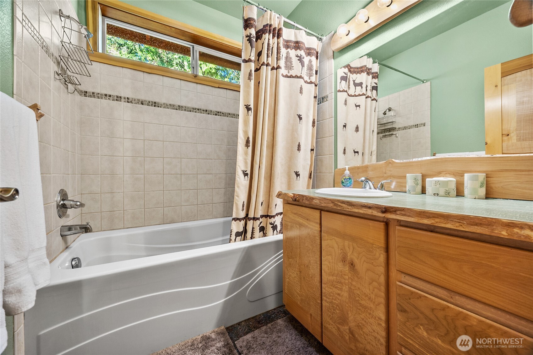 106 Timber Trail Packwood, WA 98361 - Photo 27 of 40 a bathroom with a tub a sink and a large mirror