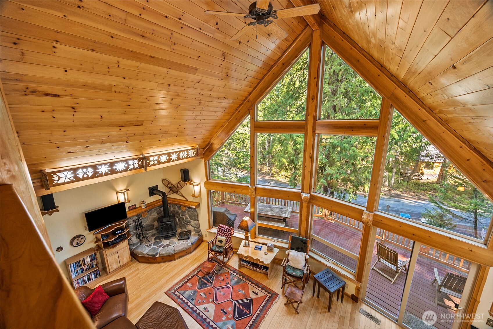 106 Timber Trail Packwood, WA 98361 - Photo 30 of 40 a view of a patio with table and chairs and wooden floor