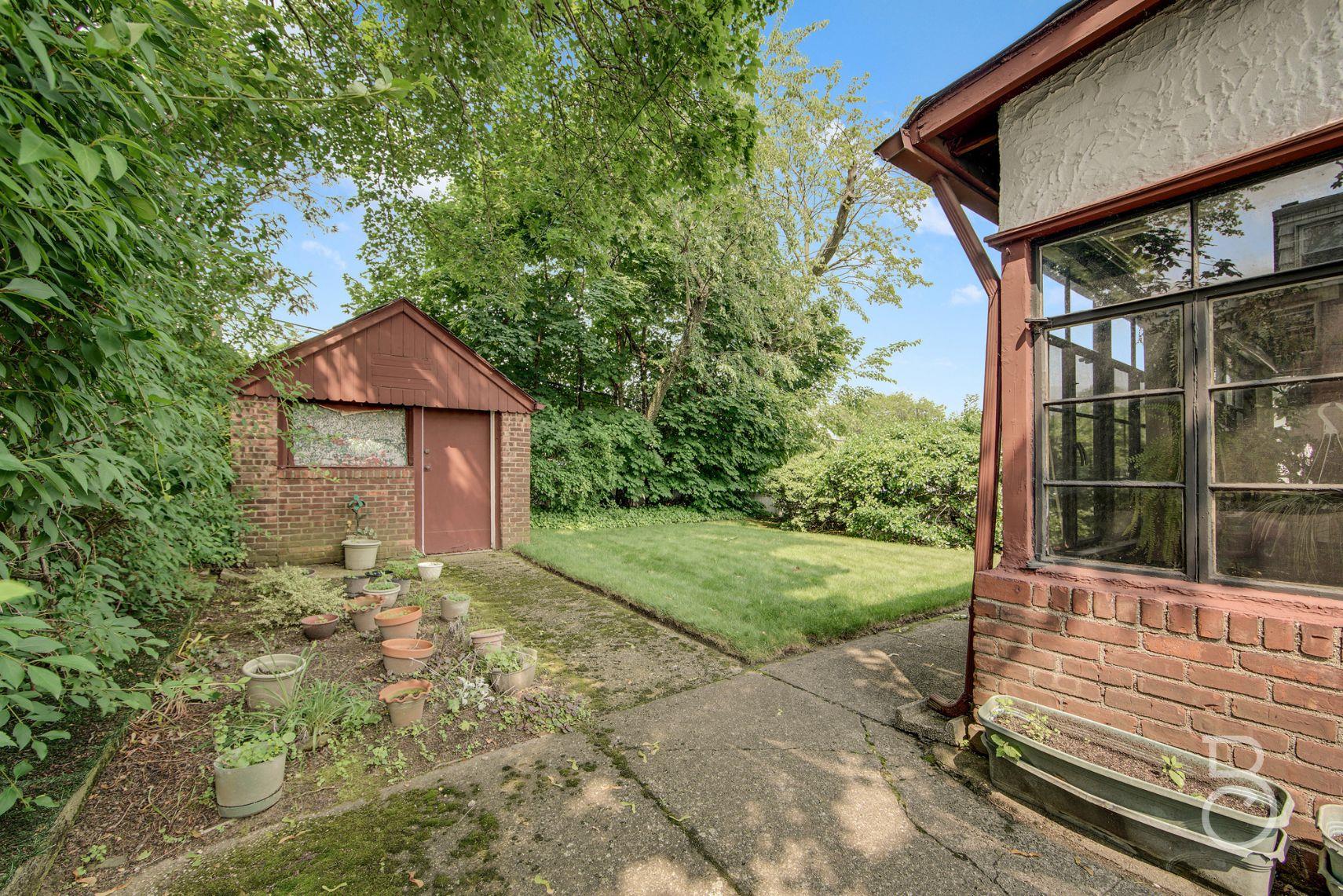 13-12 146th Street Queens, NY 11357 - Photo 11 of 11 a yellow house with trees in front of it