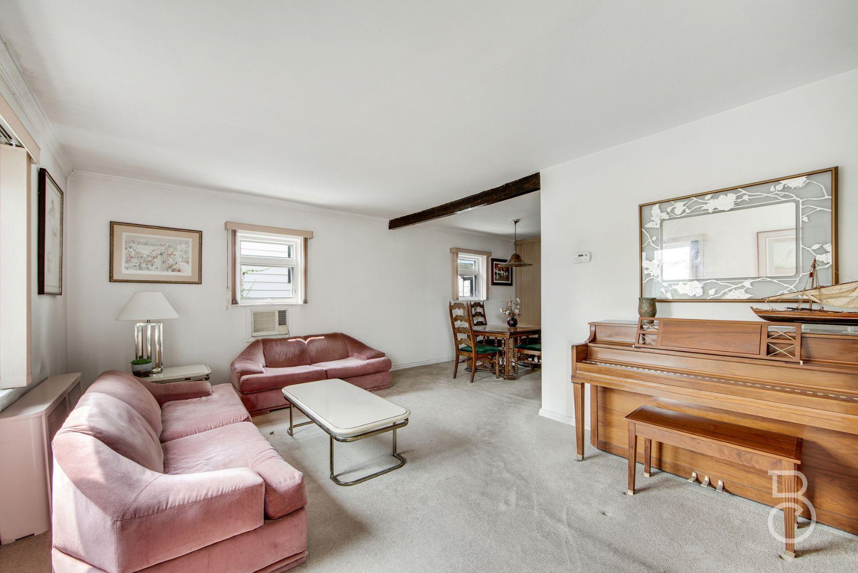 13-12 146th Street Queens, NY 11357 - Photo 2 of 11 a living room with furniture and a wooden floor