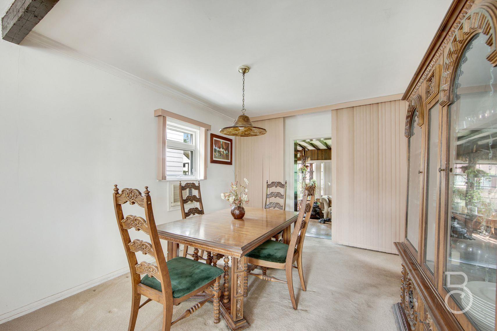 13-12 146th Street Queens, NY 11357 - Photo 4 of 11 a dining room with furniture and window