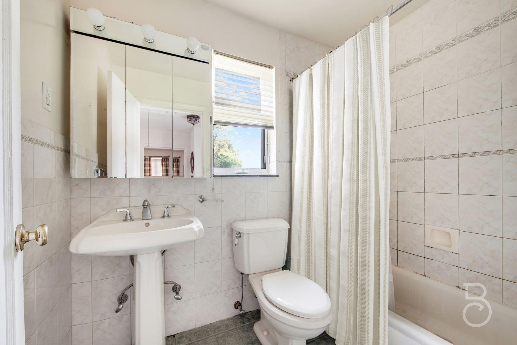 13-12 146th Street Queens, NY 11357 - Photo 6 of 11 a bathroom with a sink toilet and shower