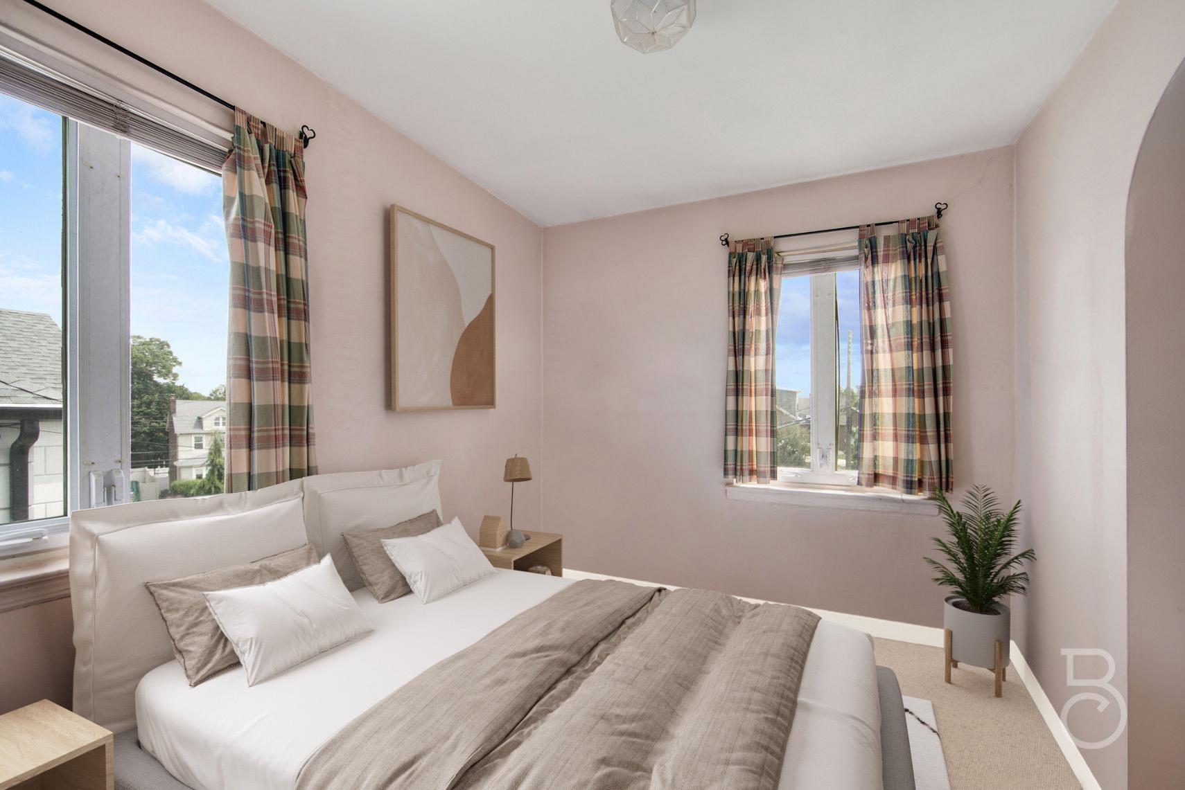 13-12 146th Street Queens, NY 11357 - Photo 9 of 11 a bedroom with a large bed and a large window