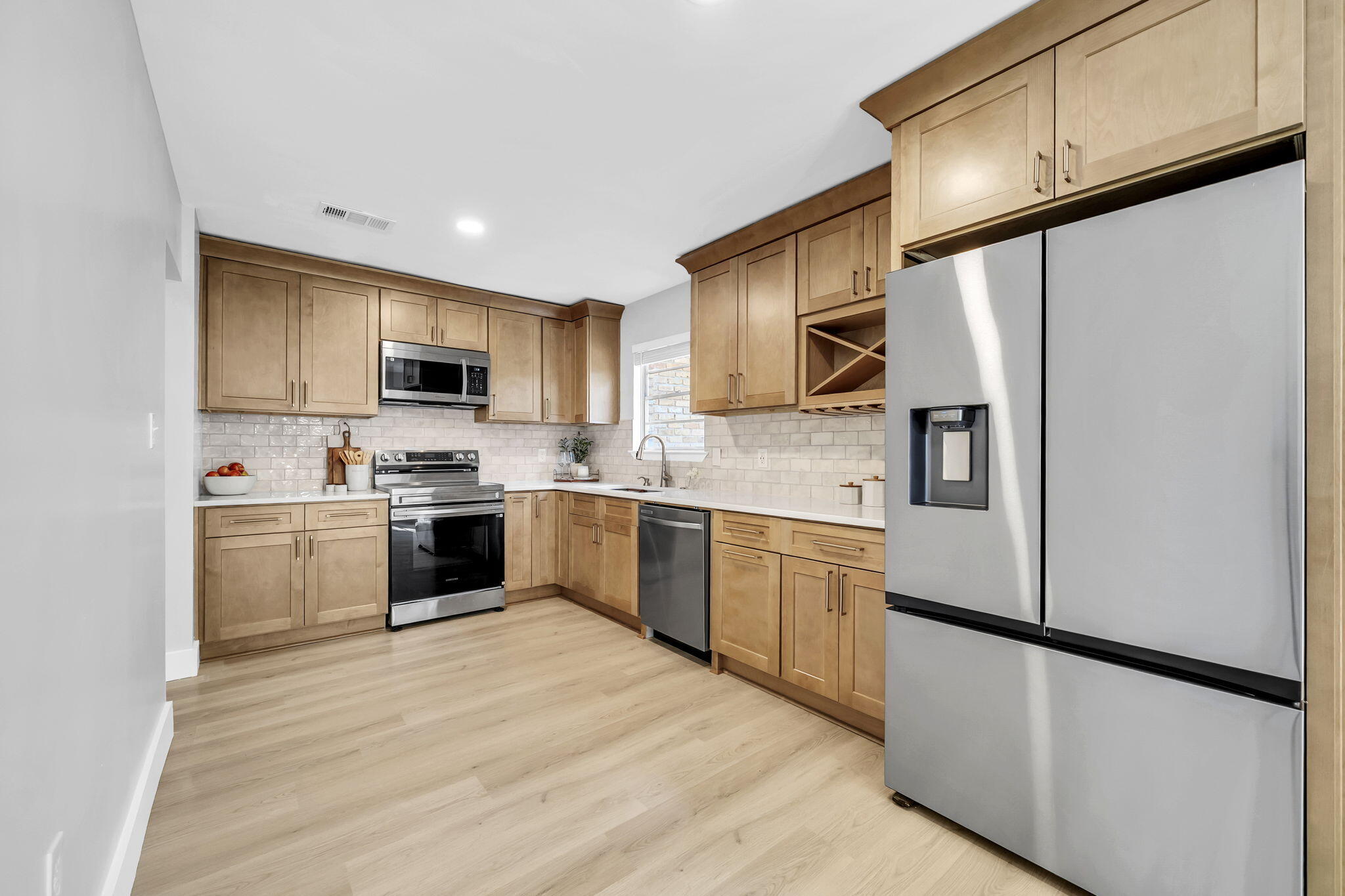 34 Hickory Avenue Shalimar, FL 32579 - Photo 13 of 57 a kitchen with white cabinets stainless steel appliances and a refrigerator