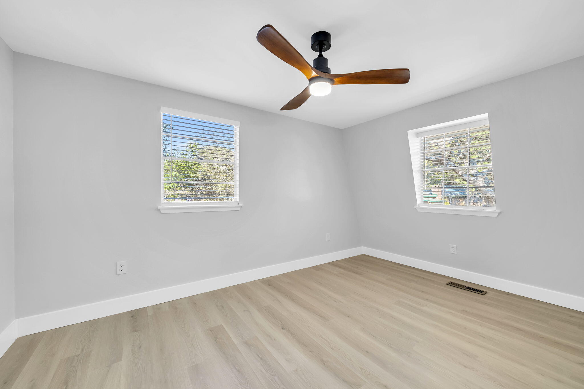 34 Hickory Avenue Shalimar, FL 32579 - Photo 25 of 57 a view of an empty room with wooden floor and a ceiling fan