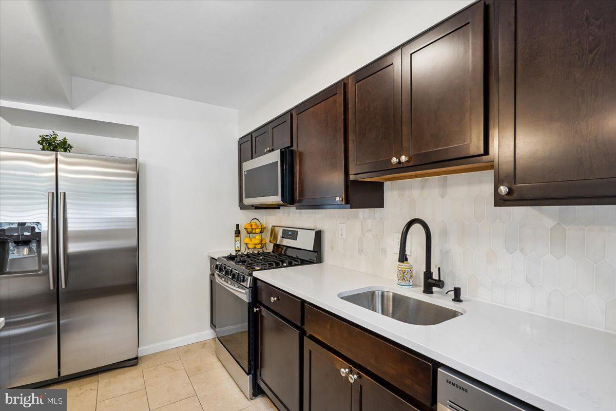 2223 16th Street Northeast Washington, DC 20018 - Photo 17 of 39 a kitchen with stainless steel appliances a refrigerator sink and microwave