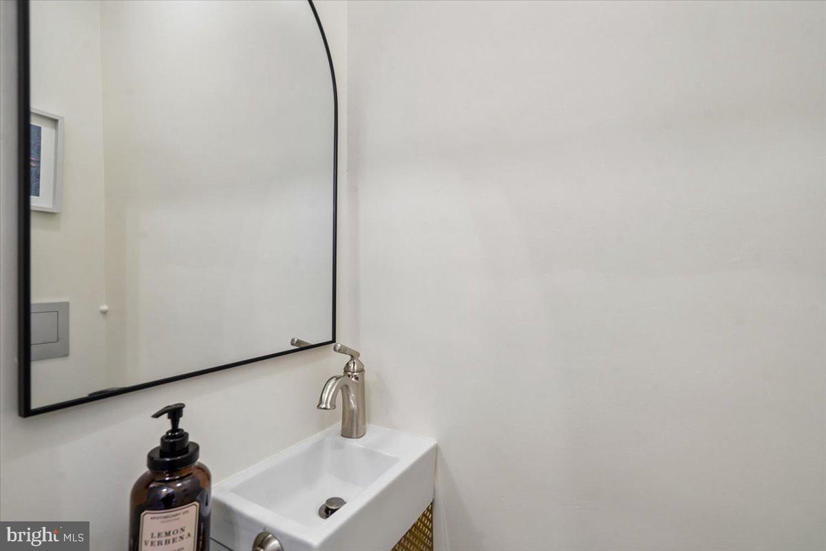 2223 16th Street Northeast Washington, DC 20018 - Photo 18 of 39 a bathroom with a sink and a mirror