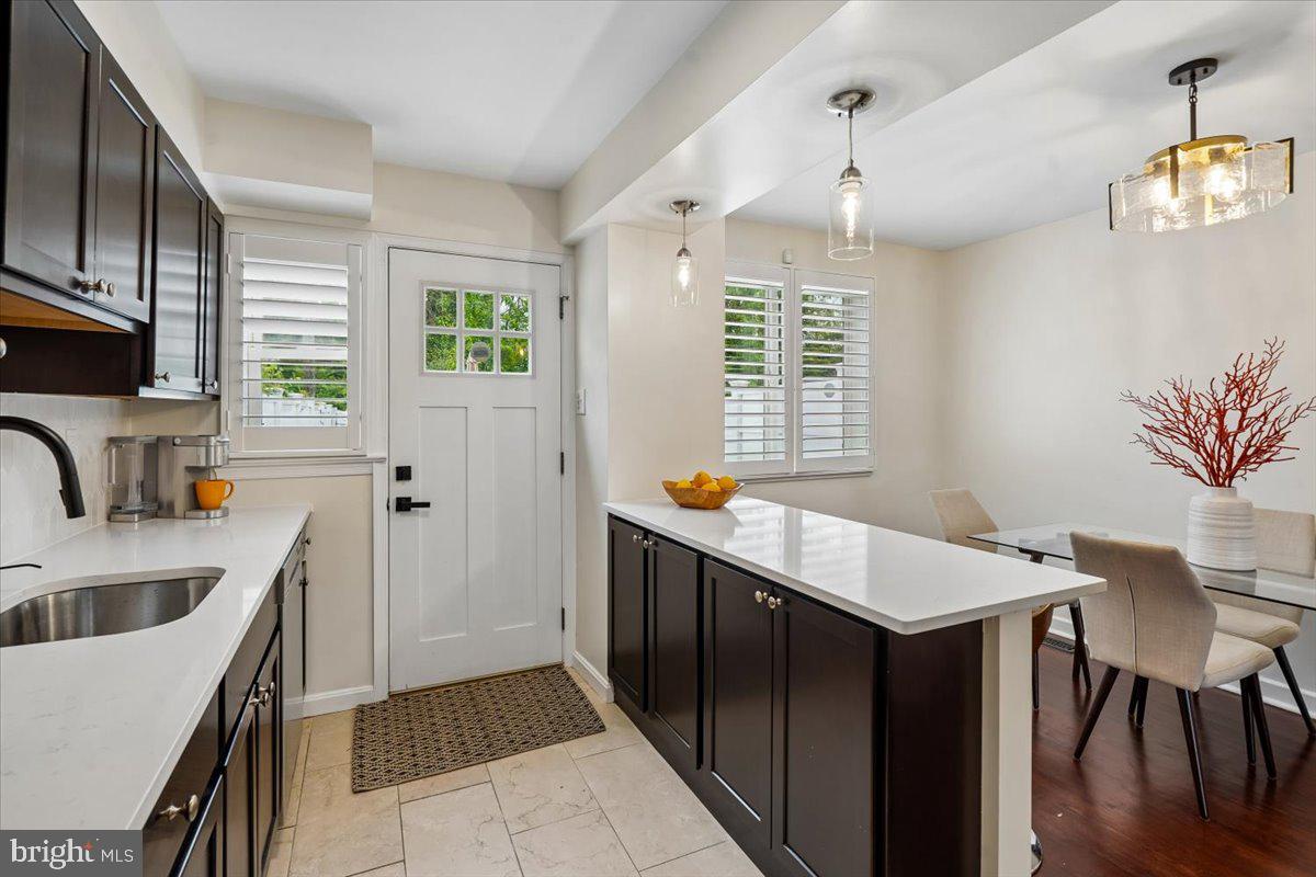 2223 16th Street Northeast Washington, DC 20018 - Photo 19 of 39 a kitchen with stainless steel appliances a table chairs and a sink