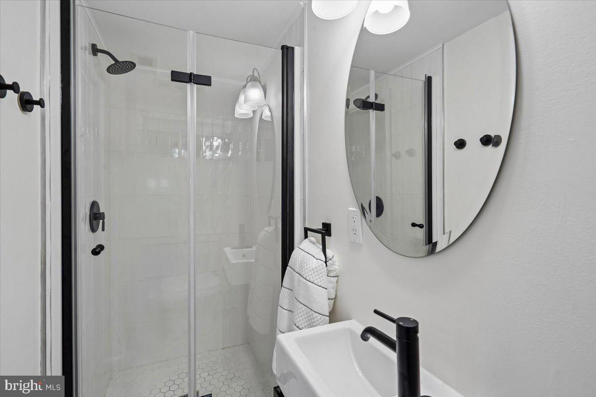 2223 16th Street Northeast Washington, DC 20018 - Photo 33 of 39 a bathroom with shower and mirror