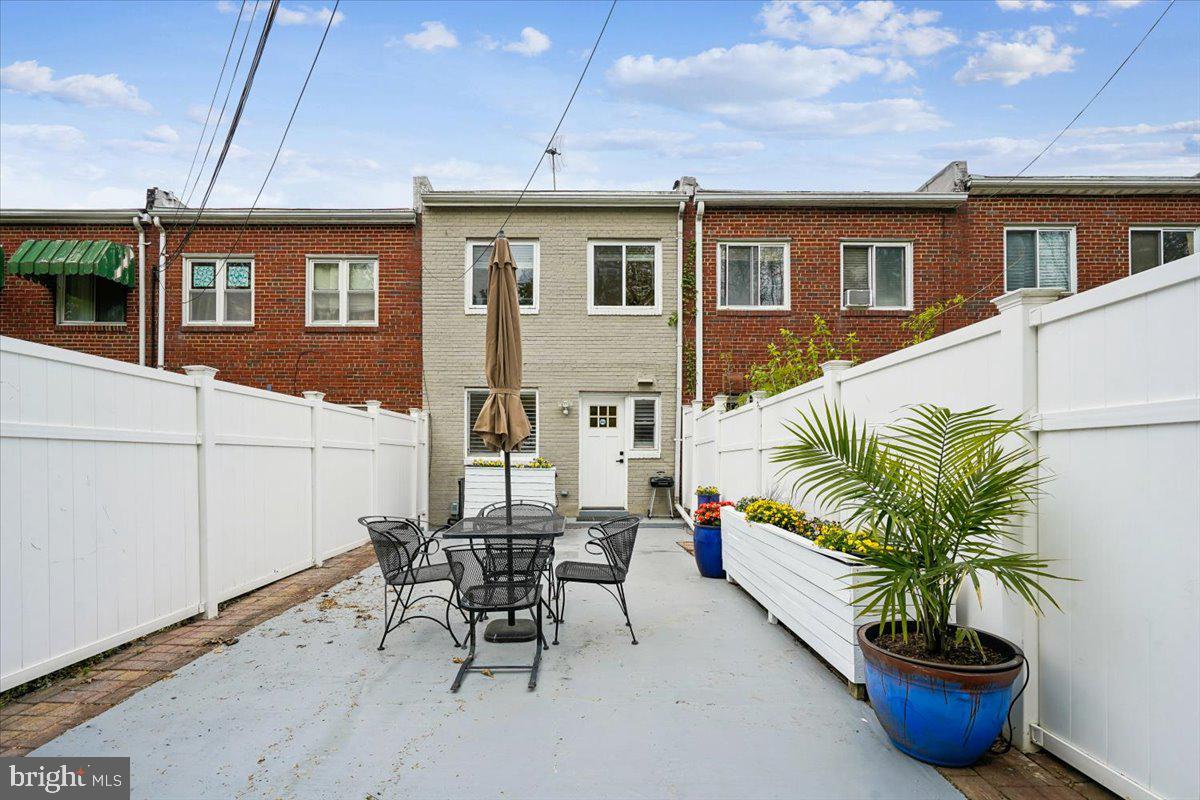 2223 16th Street Northeast Washington, DC 20018 - Photo 5 of 39 a view of a patio with table and chairs potted plants with wooden fence