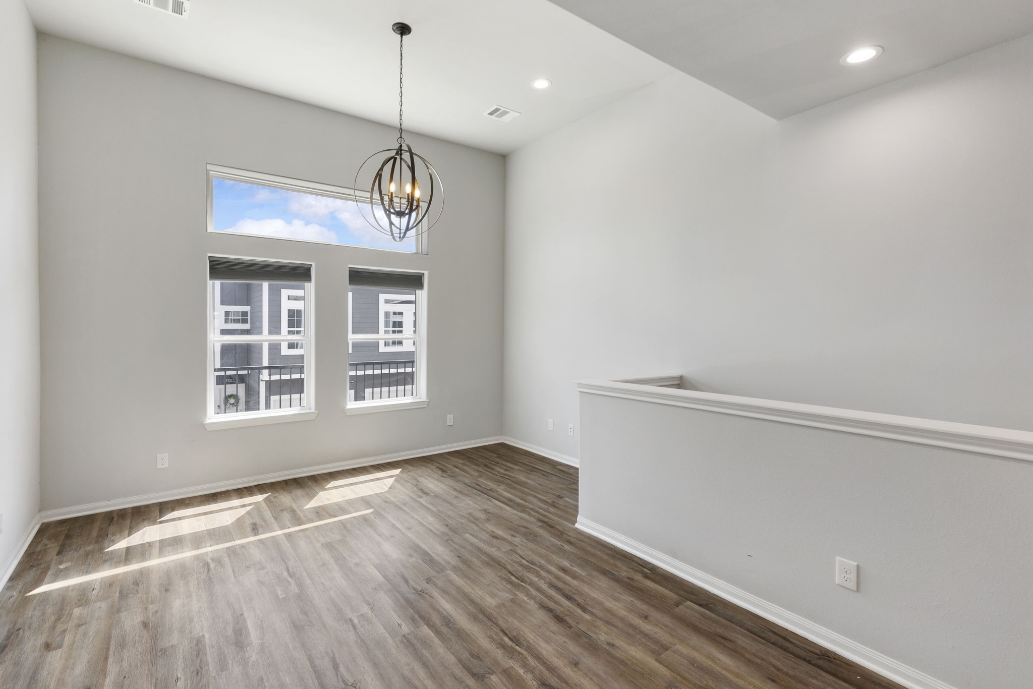 4908 Paradigm Ln Spring Spring, TX 77379 - Photo 3 of 19 a view of an empty room with wooden floor and windows