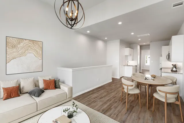 a living room with furniture and a wooden floor