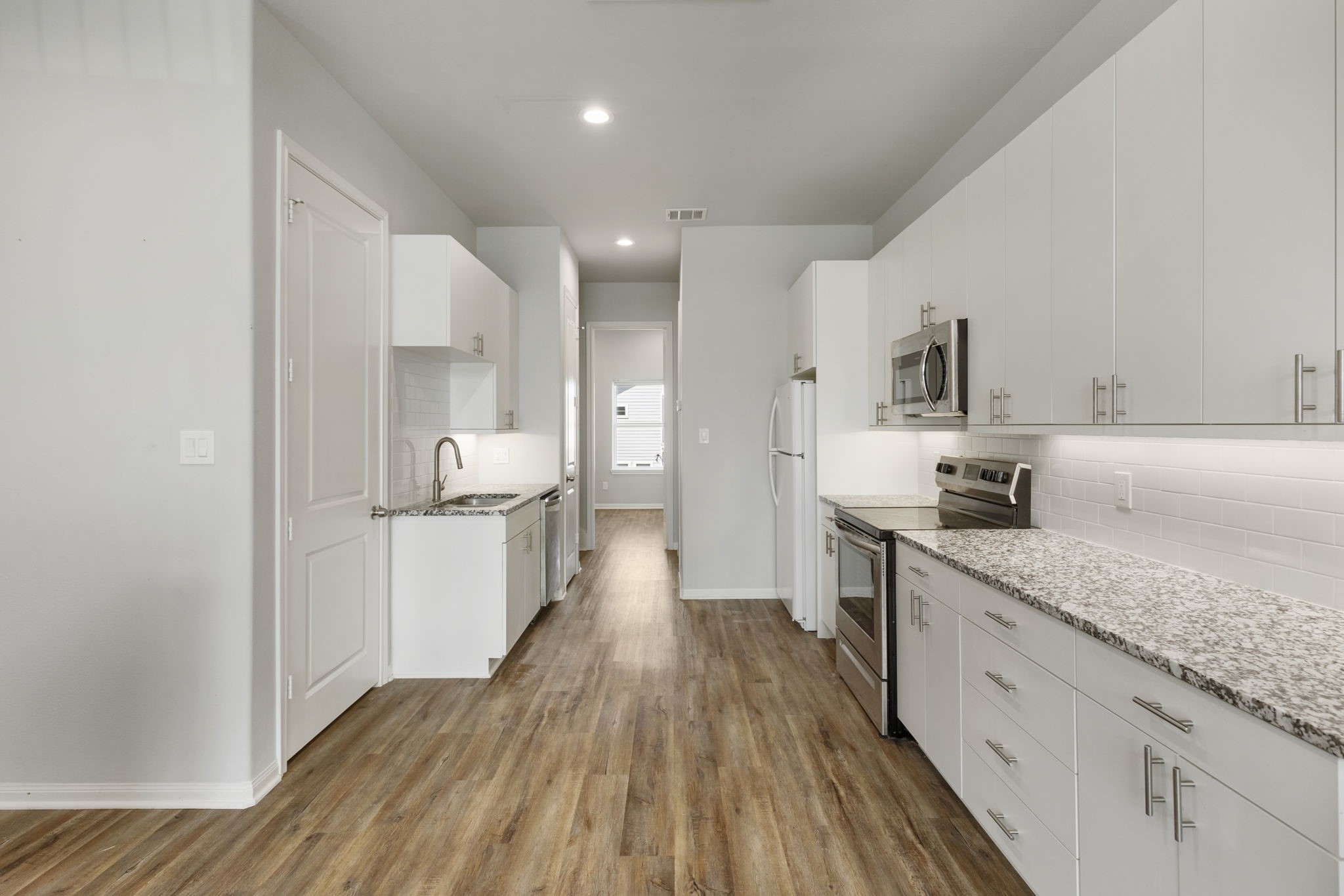 4908 Paradigm Ln Spring Spring, TX 77379 - Photo 6 of 19 a large kitchen with a lot of counter space and wooden floor