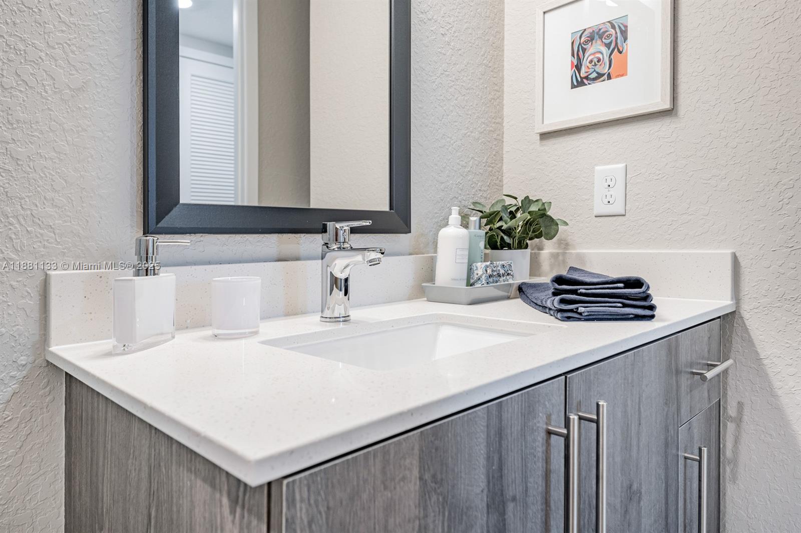 9155 Northwest 57th Street, Unit 103 Tamarac, FL 33351 - Photo 18 of 32 a bathroom with a sink and a mirror