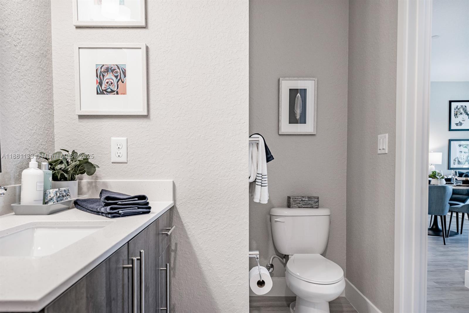 9155 Northwest 57th Street, Unit 103 Tamarac, FL 33351 - Photo 19 of 32 a bathroom with a toilet a sink and mirror