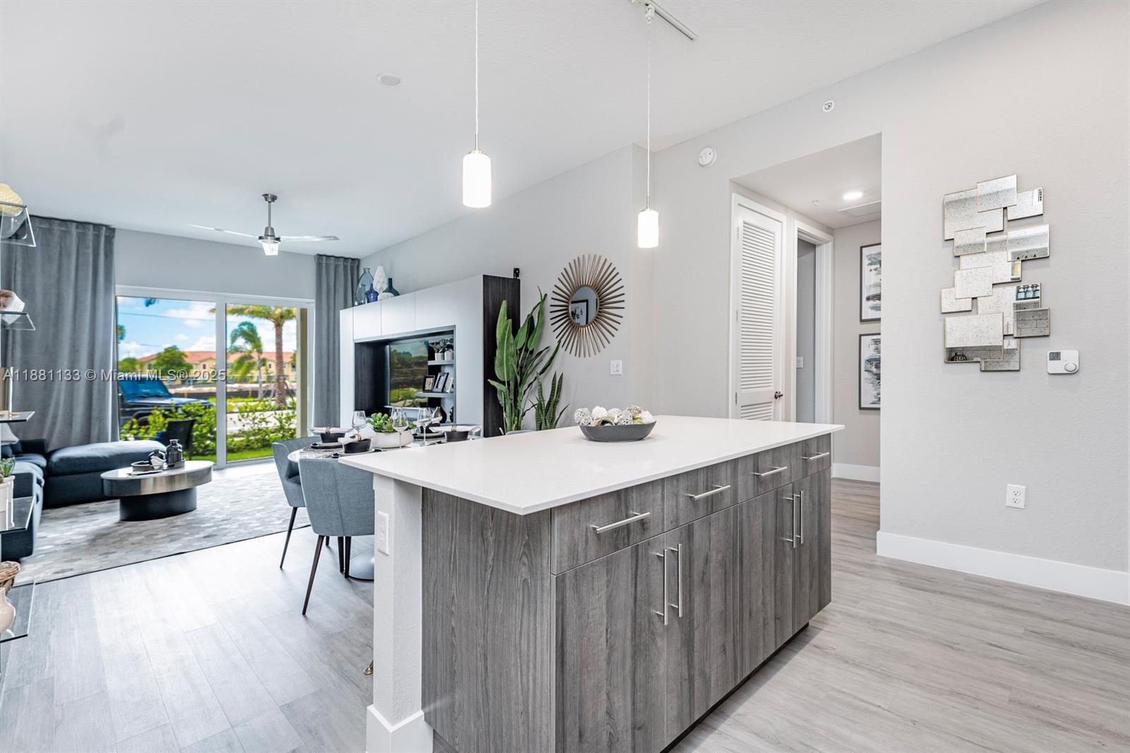 9155 Northwest 57th Street, Unit 103 Tamarac, FL 33351 - Photo 3 of 32 a kitchen with a table and chairs in it