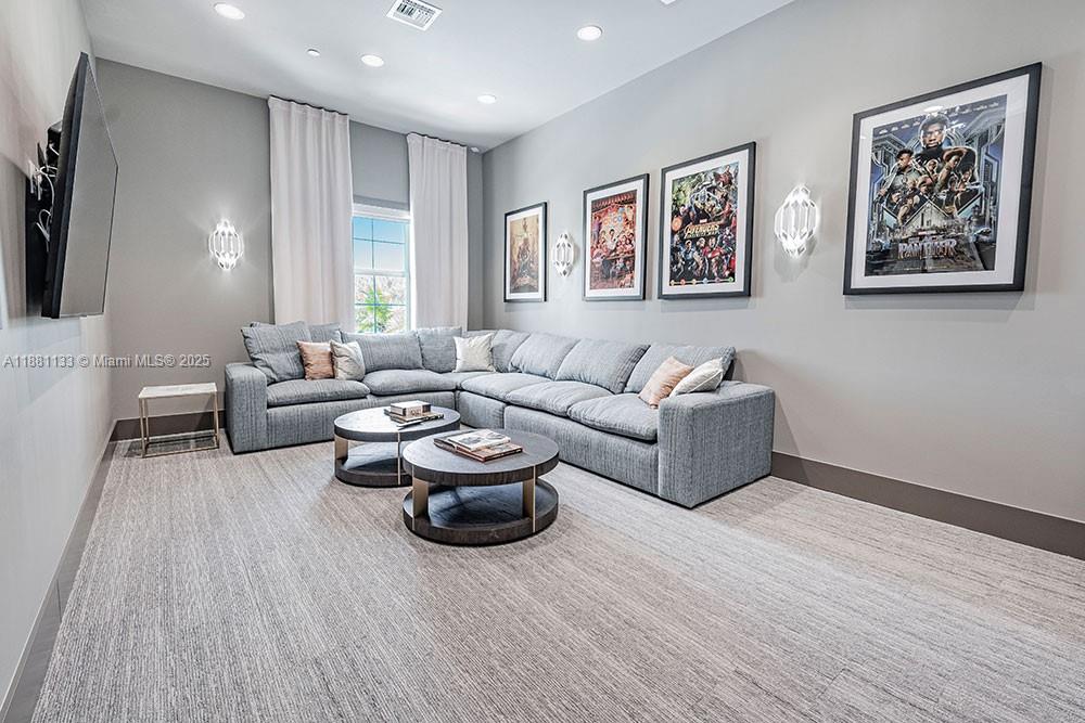 9155 Northwest 57th Street, Unit 103 Tamarac, FL 33351 - Photo 31 of 32 a living room with furniture and a wooden floor