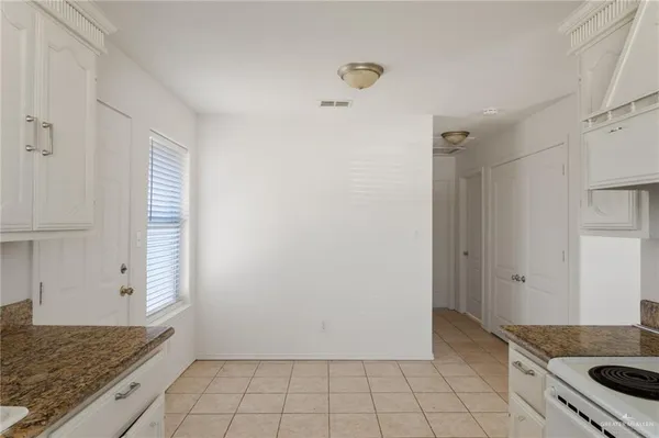 a kitchen with a stove and a refrigerator