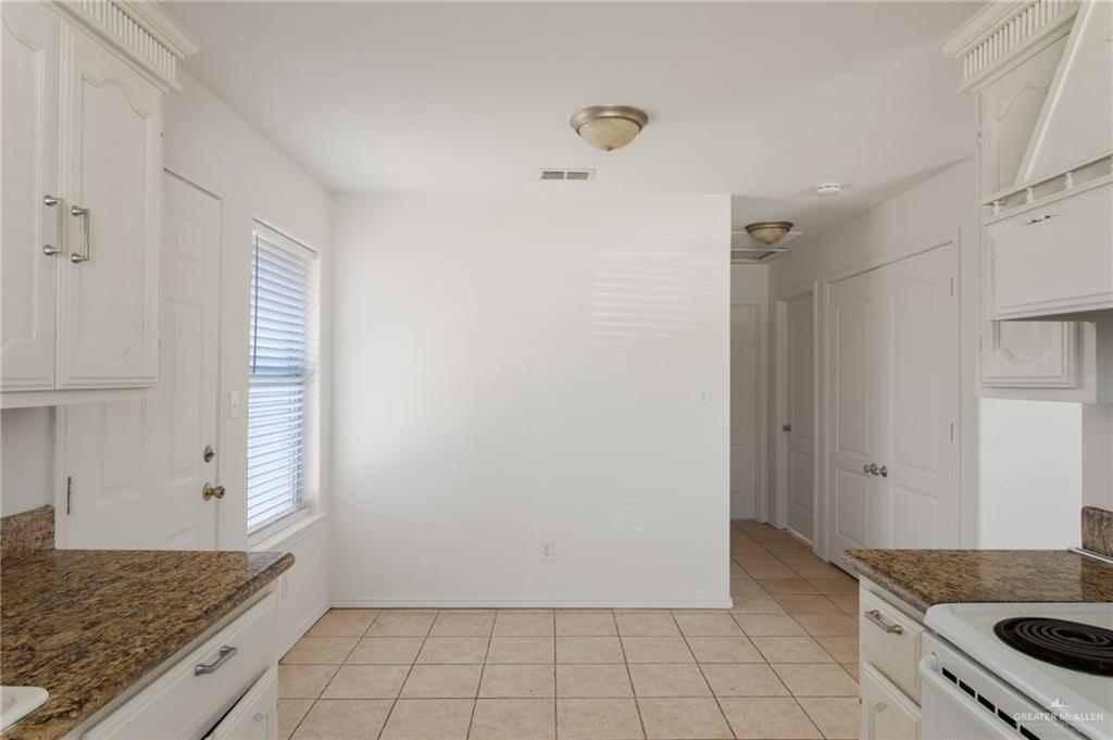 705 West Bronze Drive, Unit 1 Pharr, TX 78577 - Photo 6 of 11 a kitchen with a stove and a refrigerator
