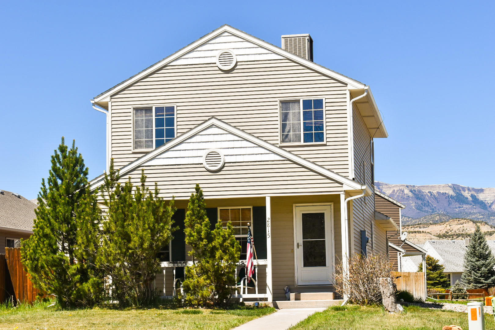 2815 Acacia Avenue Rifle, CO 81650 - Photo 1 of 14 a front view of a house with a yard