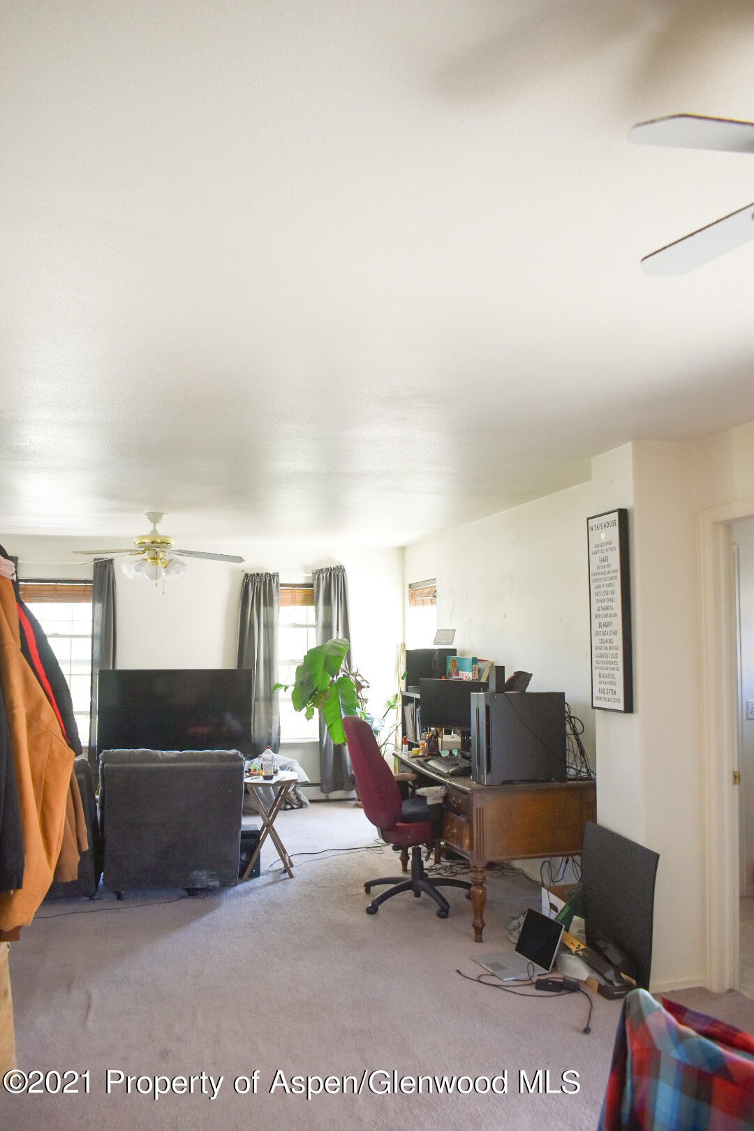 2815 Acacia Avenue Rifle, CO 81650 - Photo 12 of 14 a living room with furniture and a flat screen tv