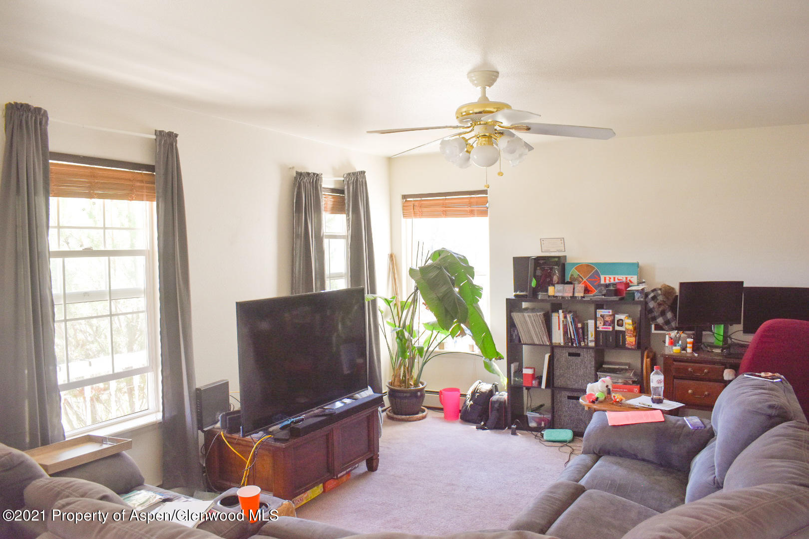 2815 Acacia Avenue Rifle, CO 81650 - Photo 3 of 14 a living room with furniture a flat screen tv and a window
