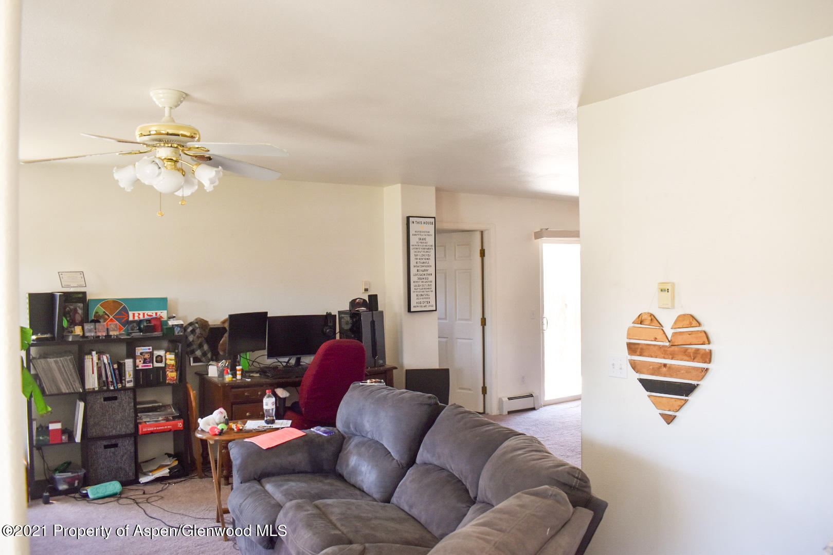 2815 Acacia Avenue Rifle, CO 81650 - Photo 4 of 14 a living room with furniture a rug and a chandelier