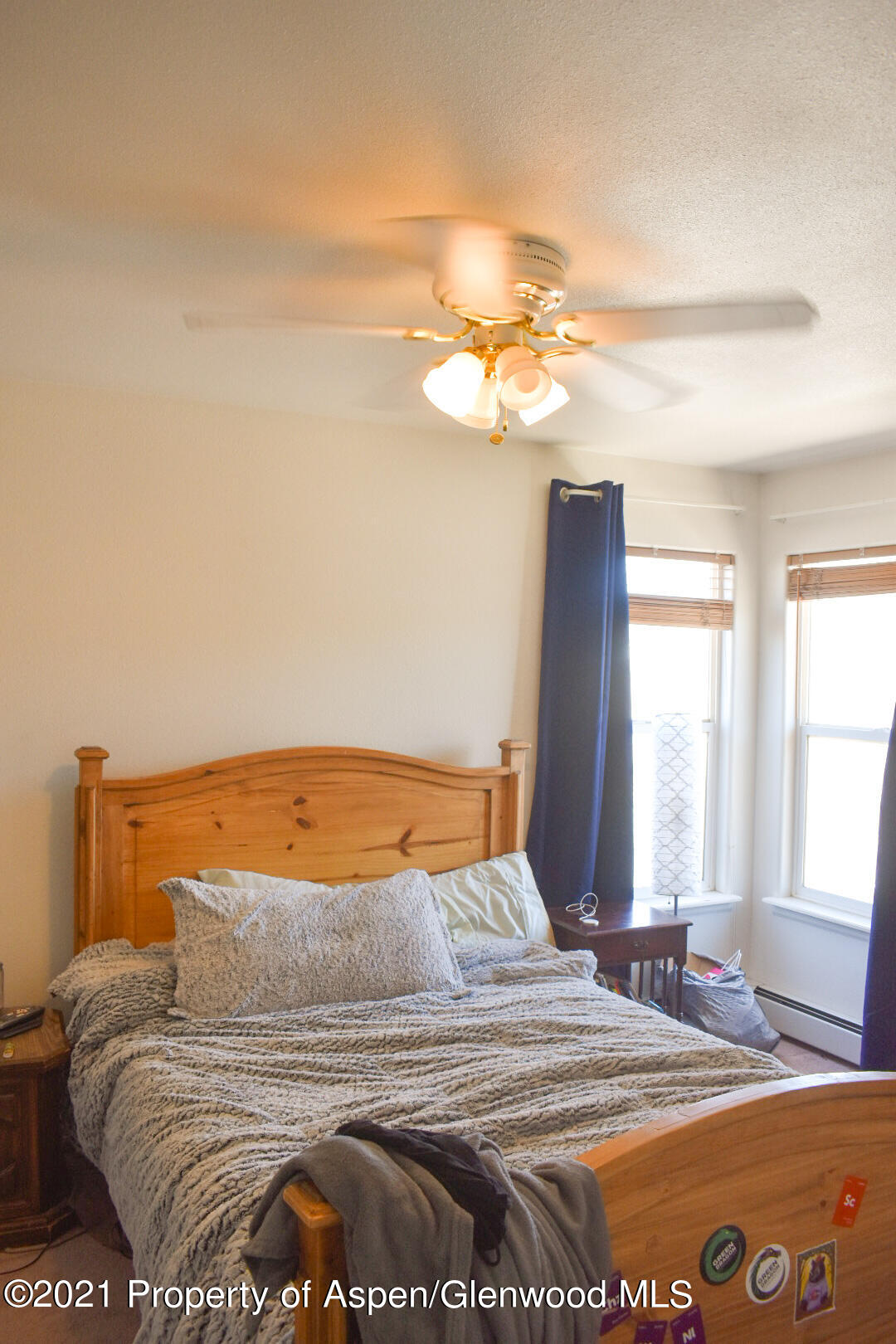 2815 Acacia Avenue Rifle, CO 81650 - Photo 6 of 14 a bedroom with a bed and a chandelier