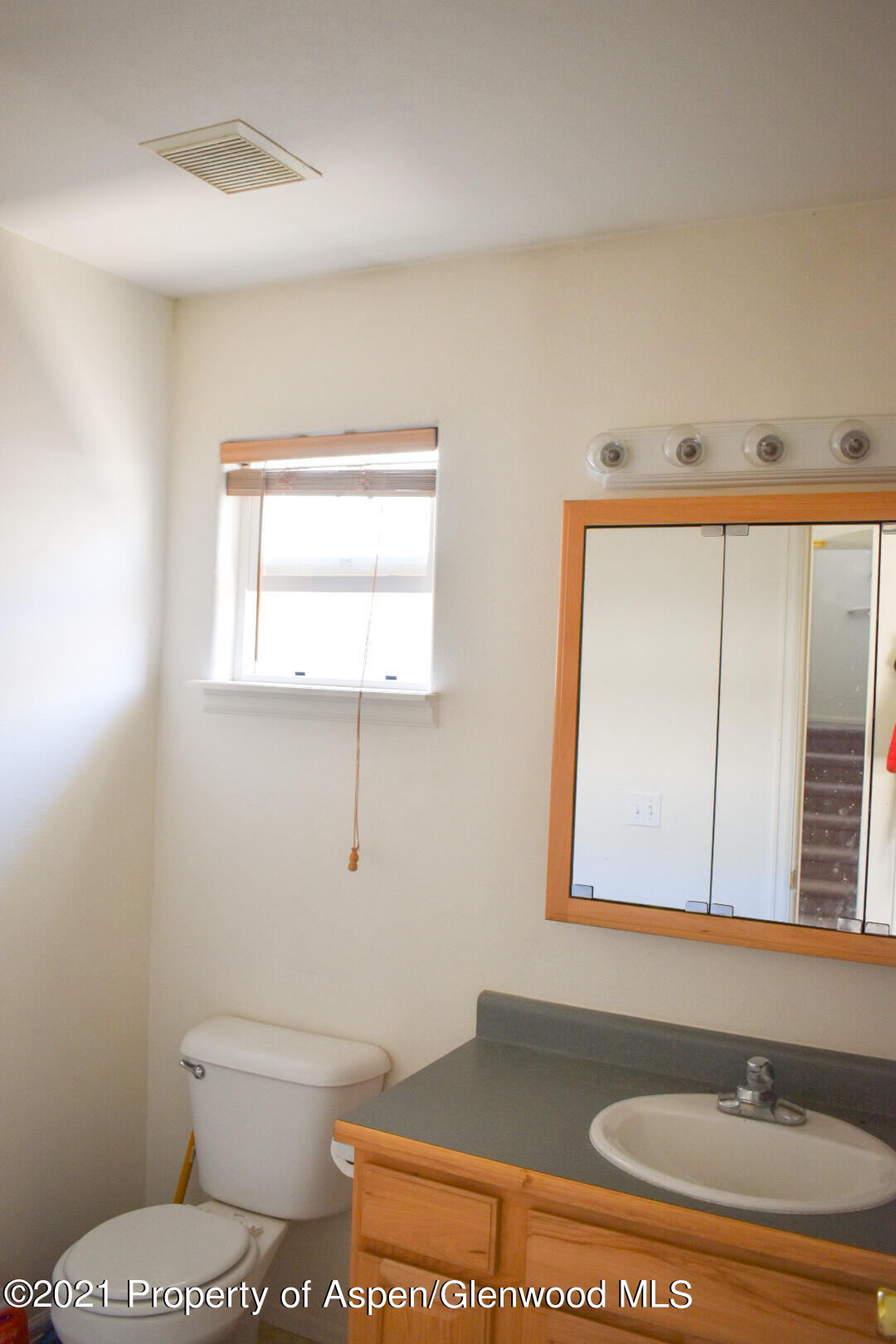 2815 Acacia Avenue Rifle, CO 81650 - Photo 9 of 14 a bathroom with a toilet sink and mirror