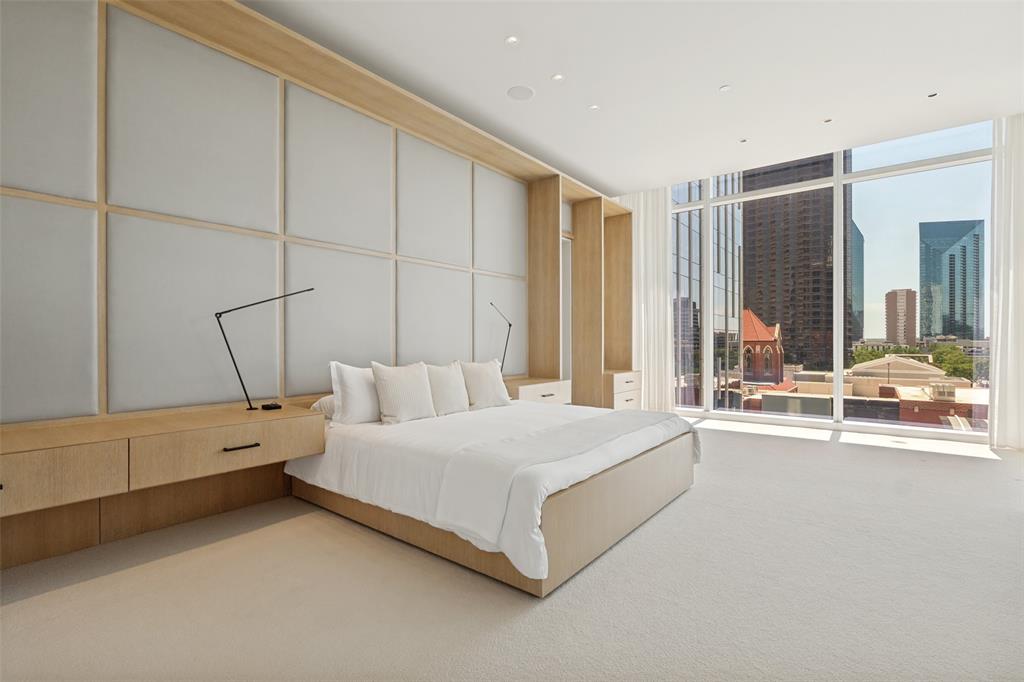 1747 Leonard Street, Unit 403 Dallas, TX 75201 - Photo 2 of 33 a bedroom with a bed and a large window