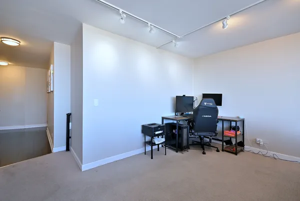 a view of a workspace with furniture and a gate