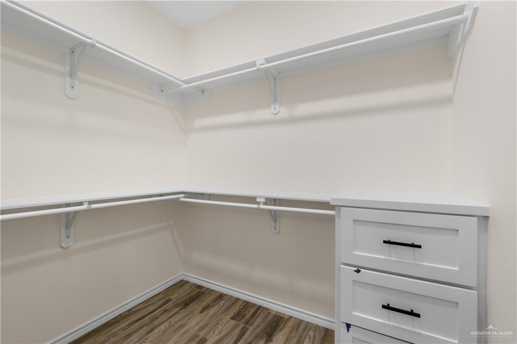 18054 Spruce Street Combes, TX 78552 - Photo 20 of 25 Custom closet system featuring wrap-around shelving and integrated hanging rods