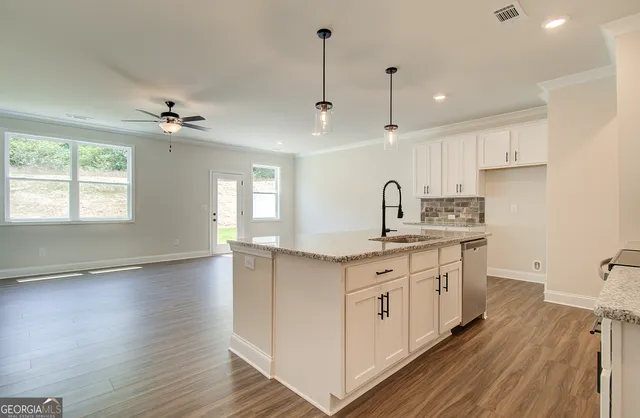 a view of hallway with sink and wooden floor