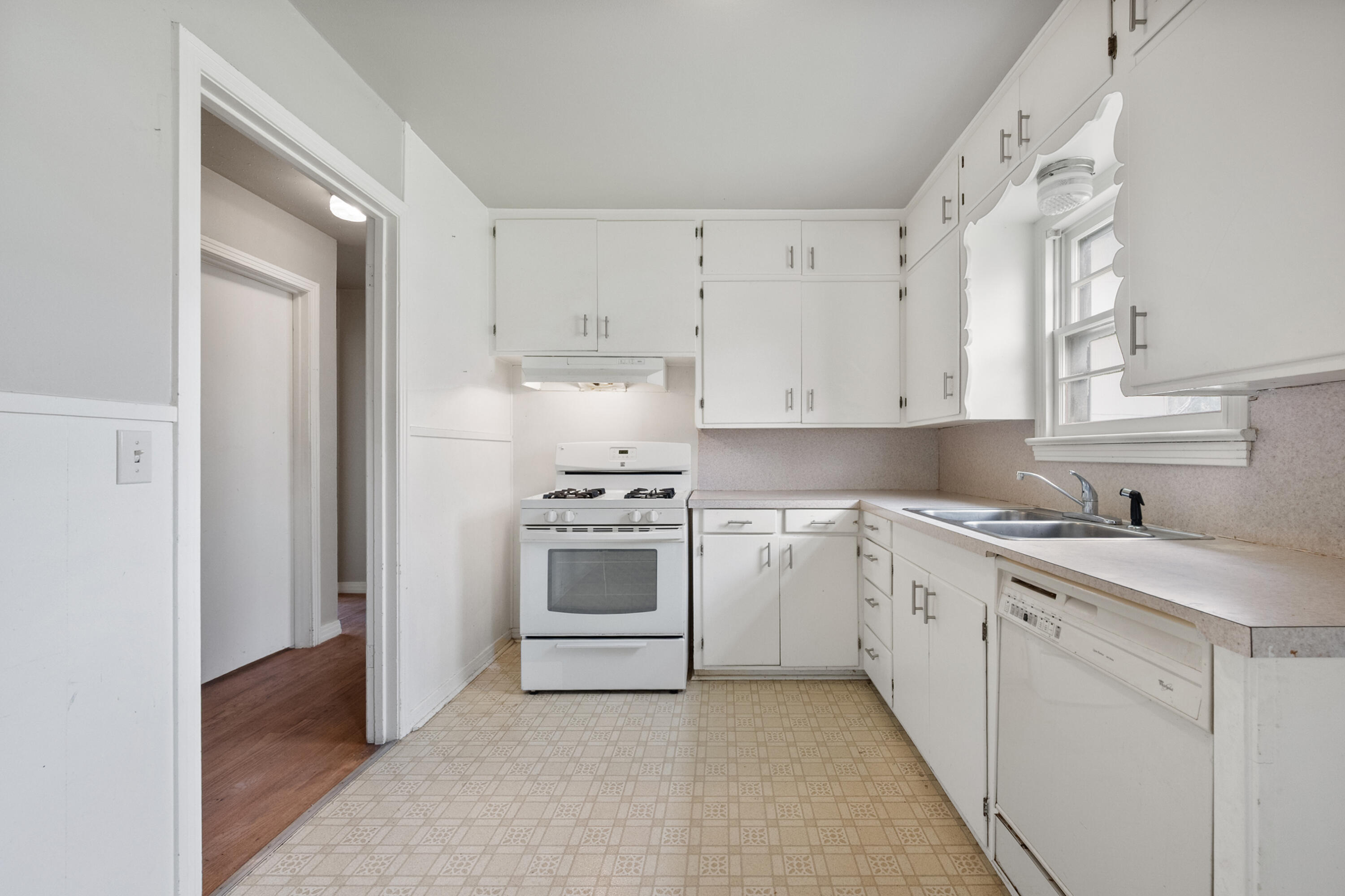 811 Zephyr Plainview, TX 79072 - Photo 14 of 25 a kitchen with cabinets appliances a sink and a window