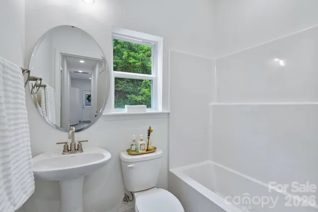 a bathroom with a toilet a sink and bathtub