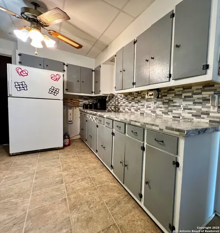 a kitchen with a stove and a refrigerator