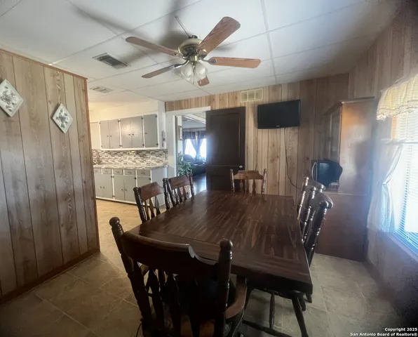 a view of a dining room with furniture and window