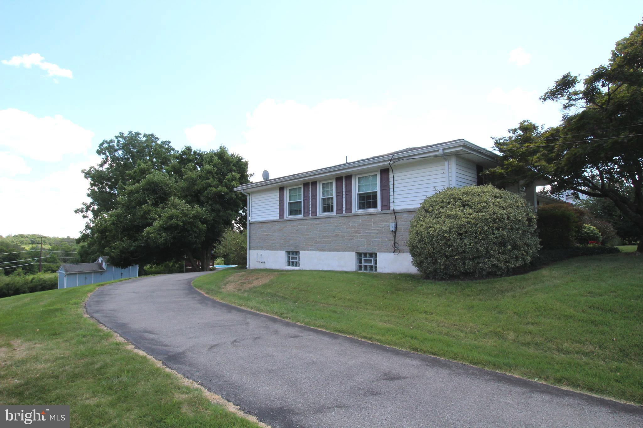 Side view with driveway that goes around to back