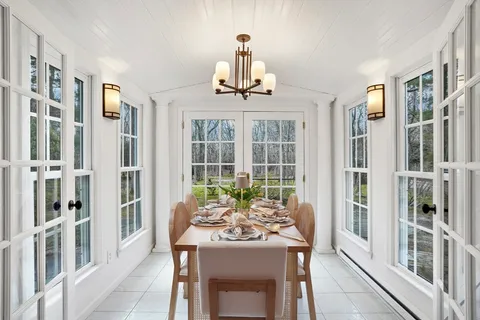 a view of a dining room with furniture window and outside view