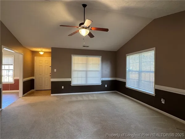 a view of wooden floor and chandelier in a room