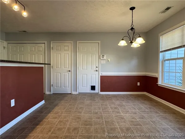 wooden floor in an empty room with a kitchen