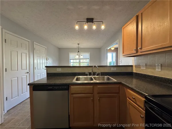 a kitchen with a sink a counter and cabinets