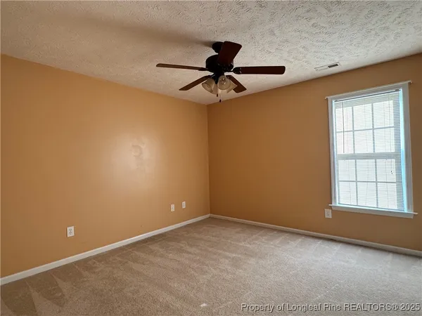 a spacious bathroom with a shower a sink and a toilet